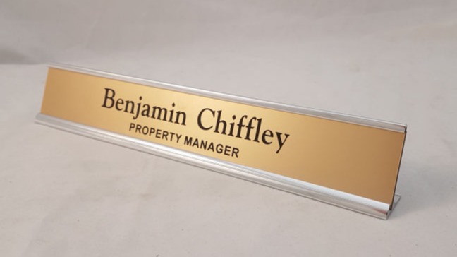 Silver aluminium desk frame with gold colored name insert
