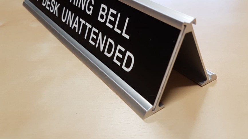 Double sided desk frame can display a message on both the front and back
