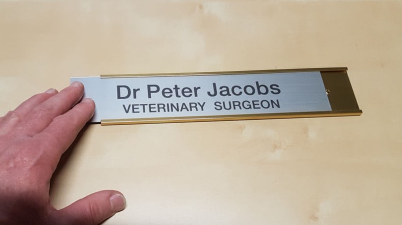 The name plates slide out of the frame if you want to replace it with a different one
