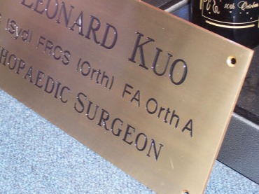 Engraved brass plaque with black enamel filled letters